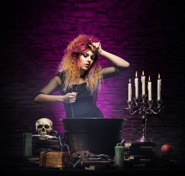 Young and beautiful witch in dungeon — Stock Photo, Image