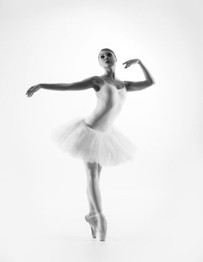 Young female ballet dancer performing a move clipart
