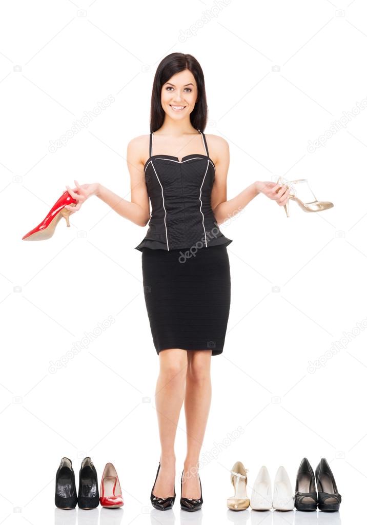 Young woman in a black dress choosing footwear
