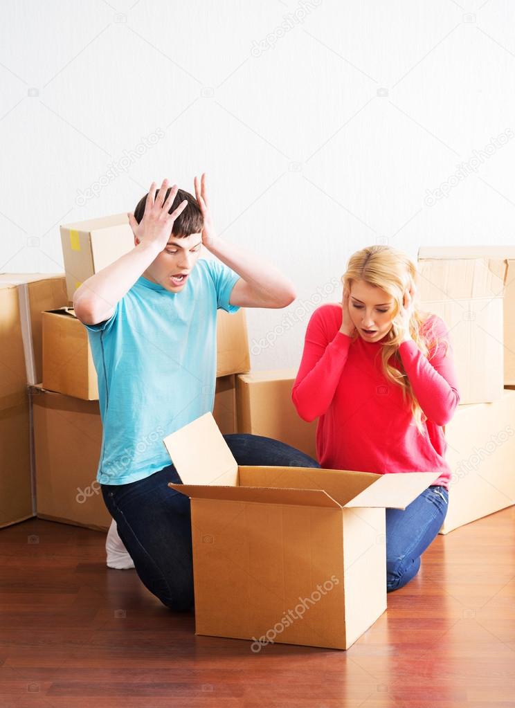 Man and woman unboxing fragile stuff