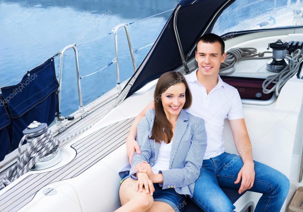 Couple relaxing together on boat.