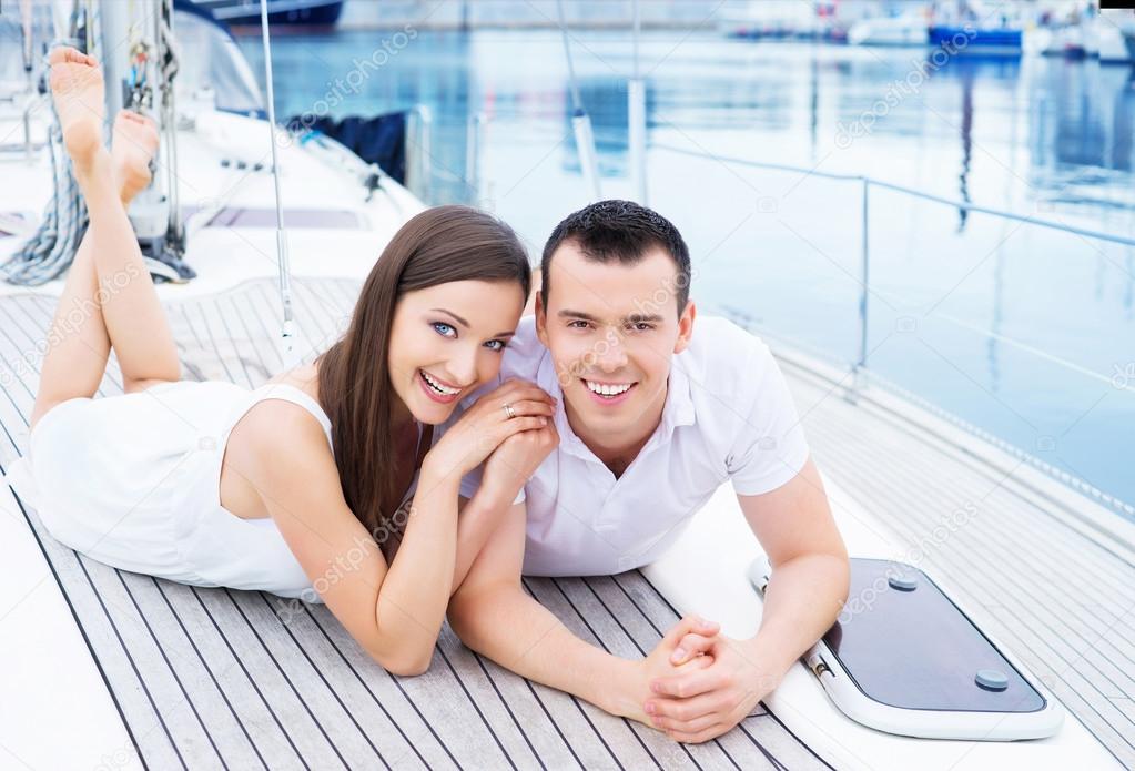 happy couple relaxing on boat