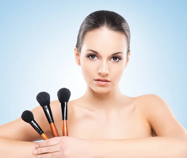 Woman with the makeup brushes — Stock Photo, Image