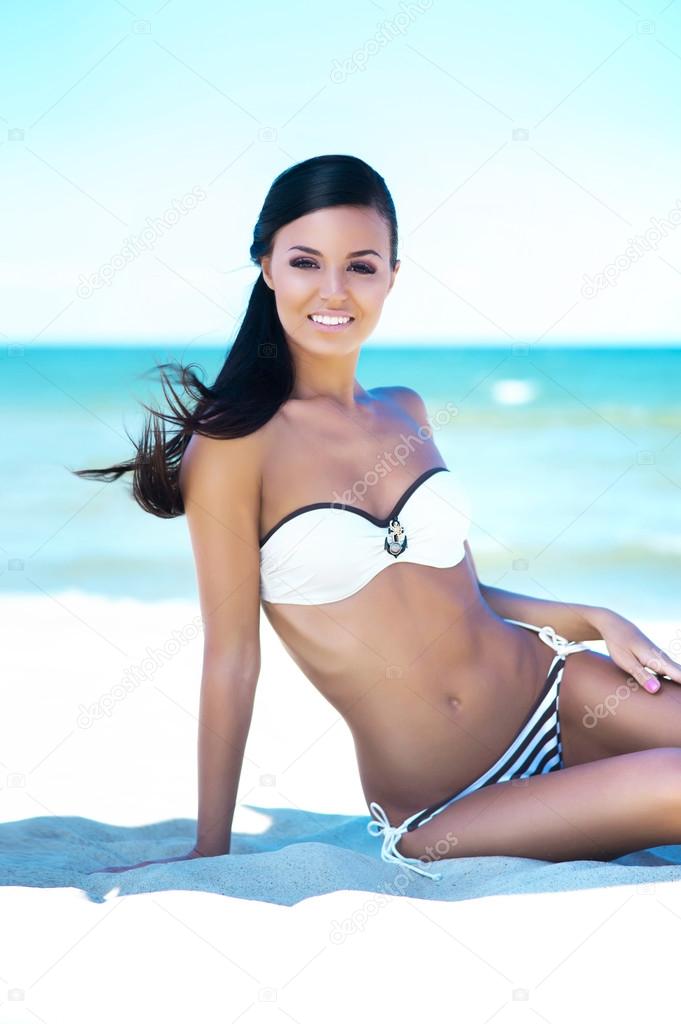 Gorgeous young girl on summer beach