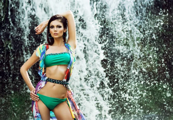 Woman in swimsuit near waterfall — Stock Photo, Image