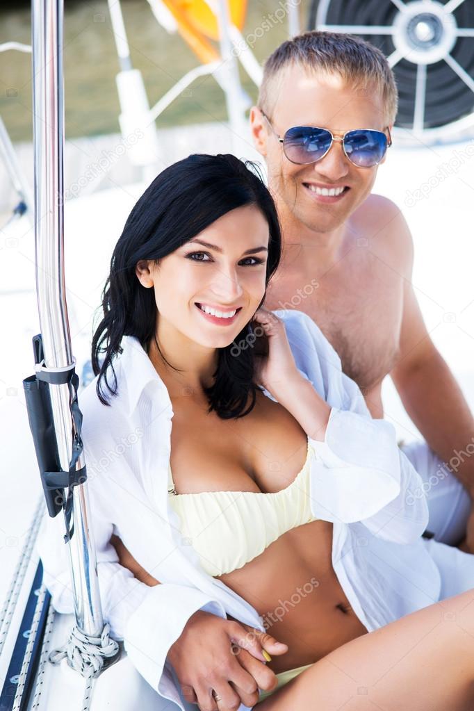 Man and woman  relaxing on sailing boat