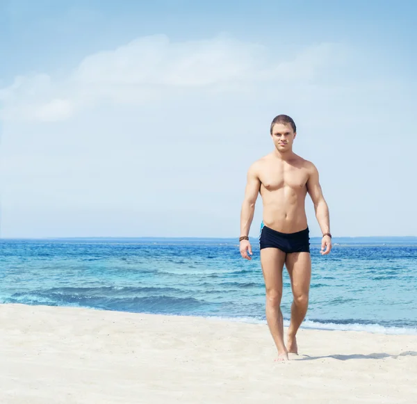 Homem musculado e bonito na praia — Fotografia de Stock