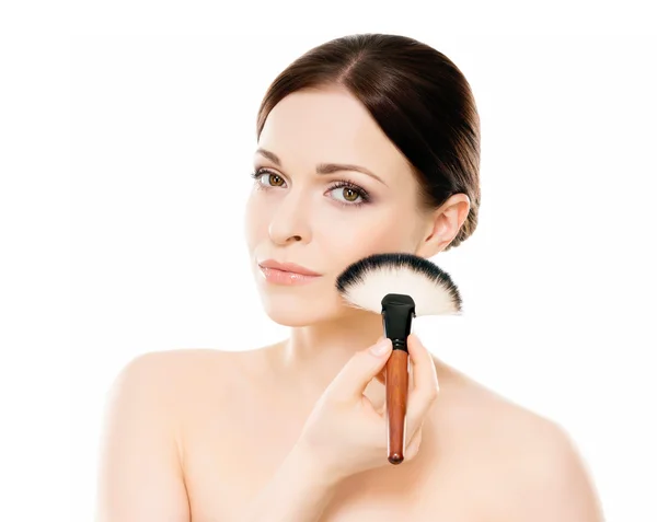 Mulher segurando escova de maquiagem Imagem De Stock