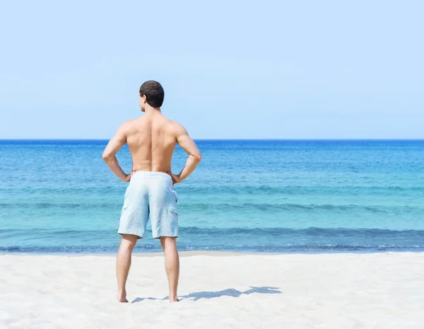 Schöner Mann am Sommerstrand — Stockfoto