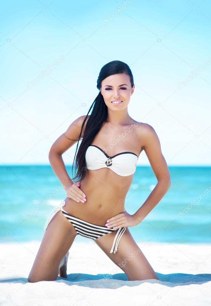 Gorgeous woman relaxing onsummer beach