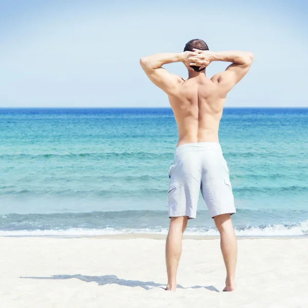 Young man on summer beach — Stock Photo, Image