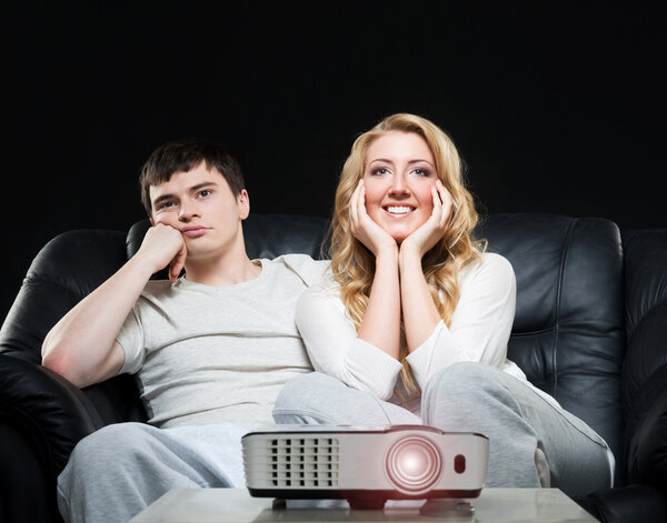 couple watching movie on projector