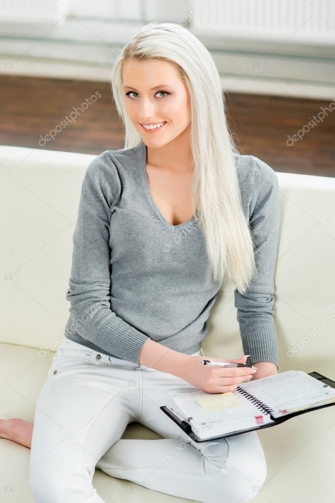 woman sitting on sofa with diary