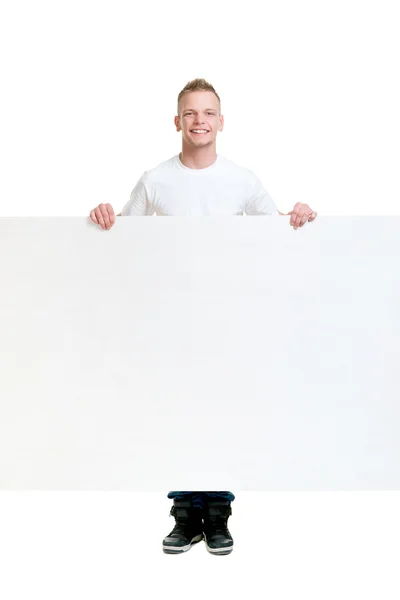 Teenager boy holding blank banner — Stock Photo, Image