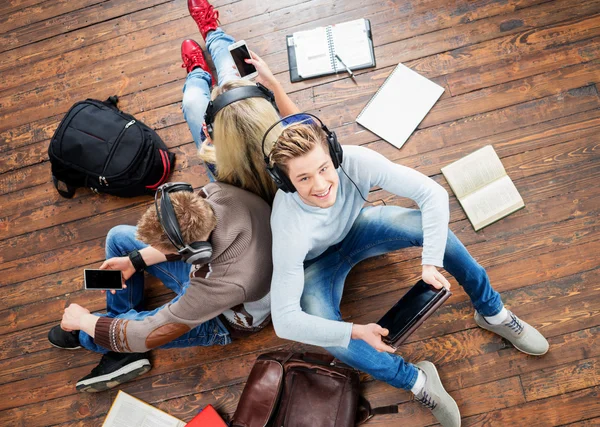 Studentengruppe sitzt auf Holzboden — Stockfoto