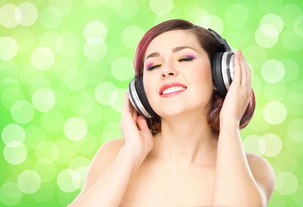 Girl listening to music in headphones Royalty Free Stock Images