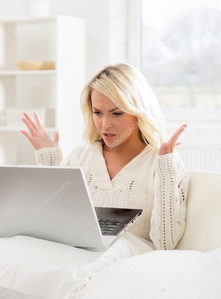 outraged woman using laptop.