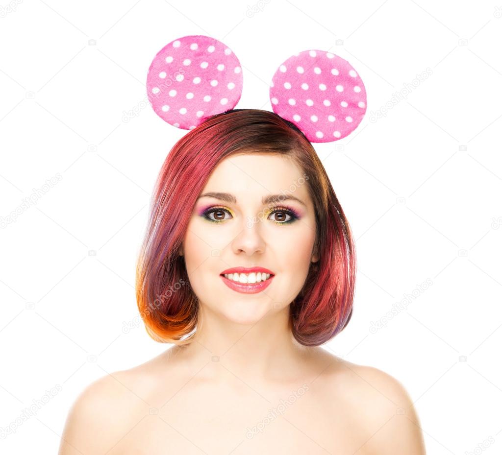smiling woman in mickey mouse ears.