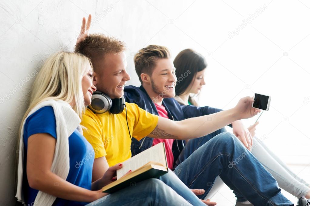 students  taking selfie on smartphone