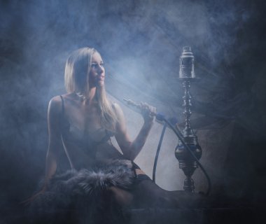 Young sexy woman in luxury underwear smoking a hookah clipart