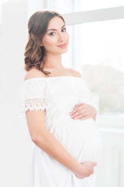 красива вагітна жінка, обіймаючи її живіт