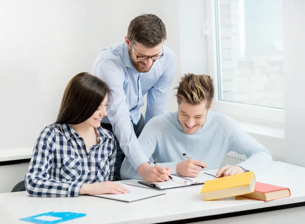 Group of teenage students studying at the lesson in the classroom — Stock Photo, Image