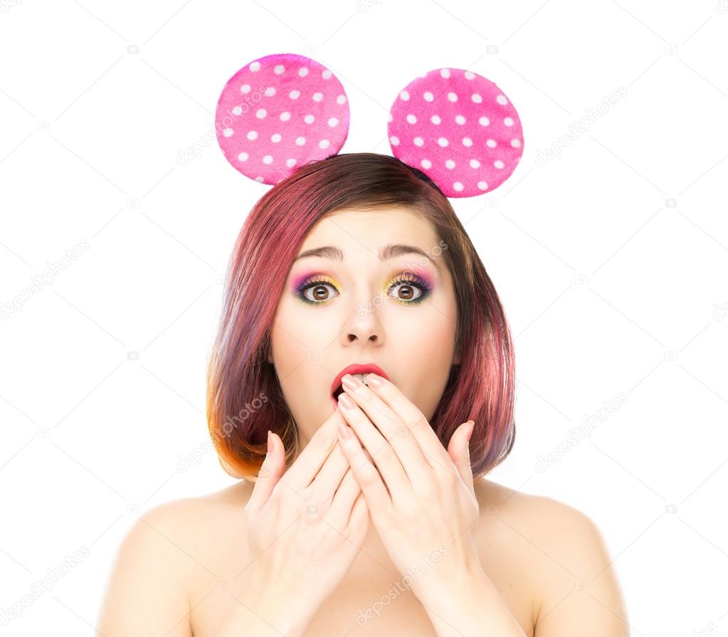 Beautiful surprised woman in mickey mouse ears