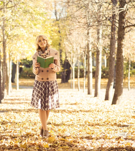 Woman  in  autumn park with book. — Stock Photo, Image