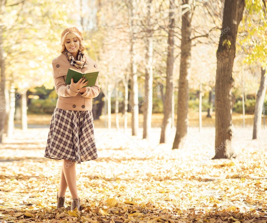 woman  in  autumn park with book.