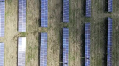 Estonya 'nın Paldiski yakınlarındaki yenilenebilir bir enerji santralindeki rüzgar türbinlerinin ve güneş panellerinin hava aracı görüntüleri. Videoda sürdürülebilir enerji üretimi, temiz enerji altyapısı ve modern yeşil teknolojinin birleştirilmesi yer alıyor.