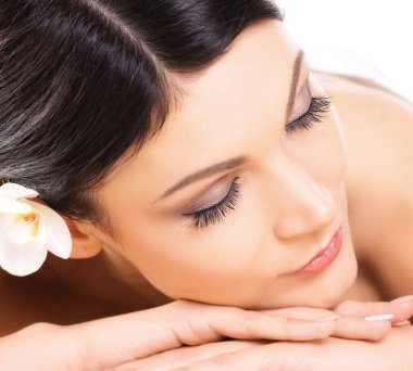 Güzel, genç ve sağlıklı kadın üzerinde bambu hasır spa salonda. Spa, sağlık ve şifa kavramı.