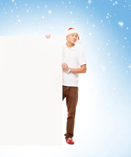 Hombre en sombrero de Navidad con cartelera en blanco —  Fotos de Stock