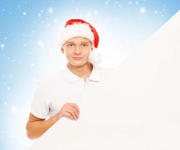Hombre en sombrero de Navidad con cartelera en blanco — Foto de Stock