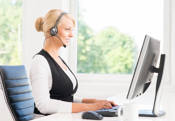 Mujer en auriculares trabajando en el centro de llamadas . —  Fotos de Stock