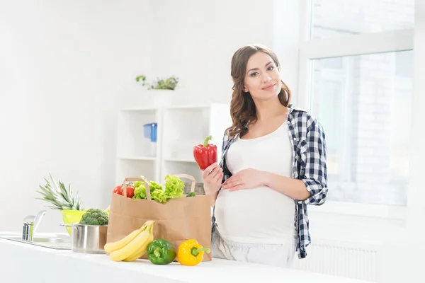 Mujer en la cocina con bolsa de compras — Foto de Stock