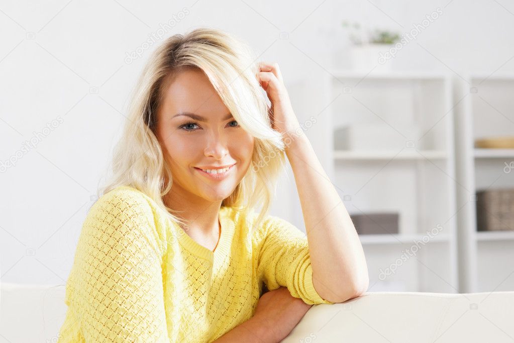 woman resting on sofa at home