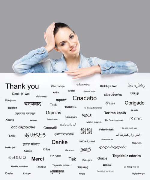 Beautiful girl with a banner of world's different languages — Stock Photo, Image
