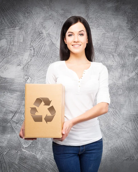 Young and attractive girl with a cardboard box — Stock Photo, Image