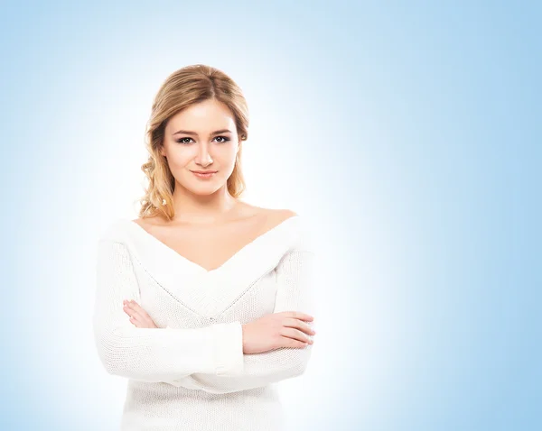 Beautiful blond in white knitwear on blue background — Stock Photo, Image