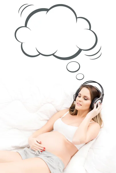 Beautiful pregnant woman listening to the music — Stock Photo, Image