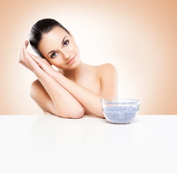 Portrait of young, beautiful and healthy woman with a mineral salt — Stock Photo, Image