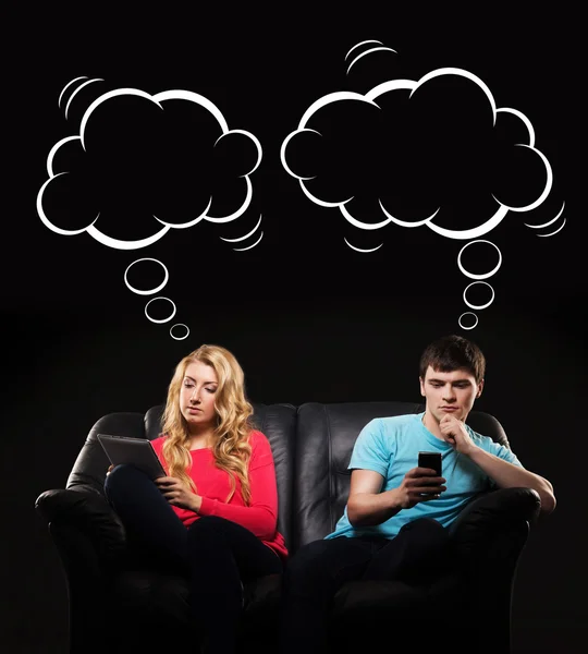 Boy and girl sitting separately with smartphones — Stock Photo, Image