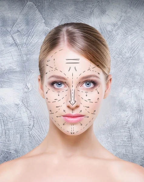 Young woman with arrows on face — Stock Photo, Image