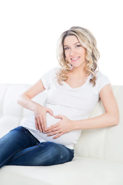 Pregnant woman making heart with her hands Royalty Free Stock Photos