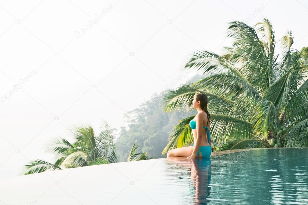 Woma sitting in poolside in the mountains