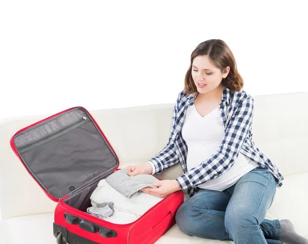 Young pregnant woman packing on a sofa — Stock Photo, Image