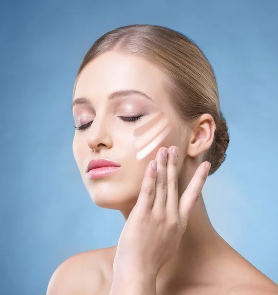 Woman with a foundation cream on her face — Stock Photo, Image