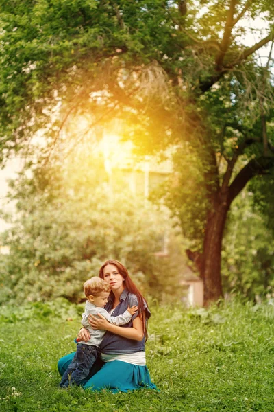 Corps complet de la famille heureuse dans le parc de la ville au coucher du soleil — Photo