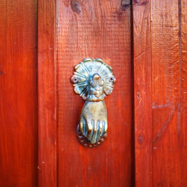 Vintage door knocker like hand on red — Stock Photo, Image