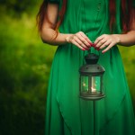 Woman holding lantern with candle Woman holding lantern with candle